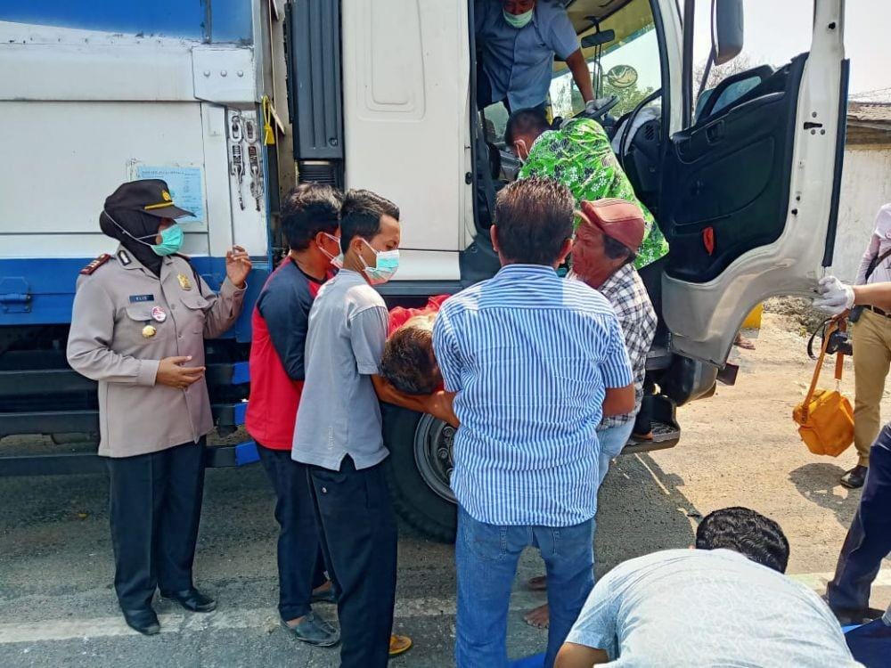 Petugas kepolisian Polsek Jenu mengevakuasi korban dari dalam mobil truk yang dikendarai (24/10). IDN Times/Imron