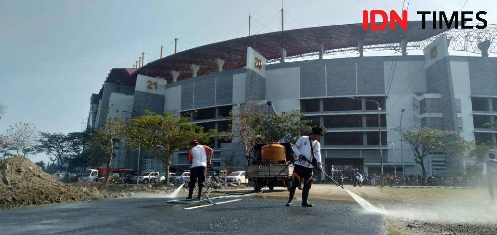 Petugas Dinas Kebersihan dan Ruang Terbuka Hijau (DKRTH) tampak menyiram jalan masuk menuju GBT, Jumat (8/11). IDN Times/Idfy