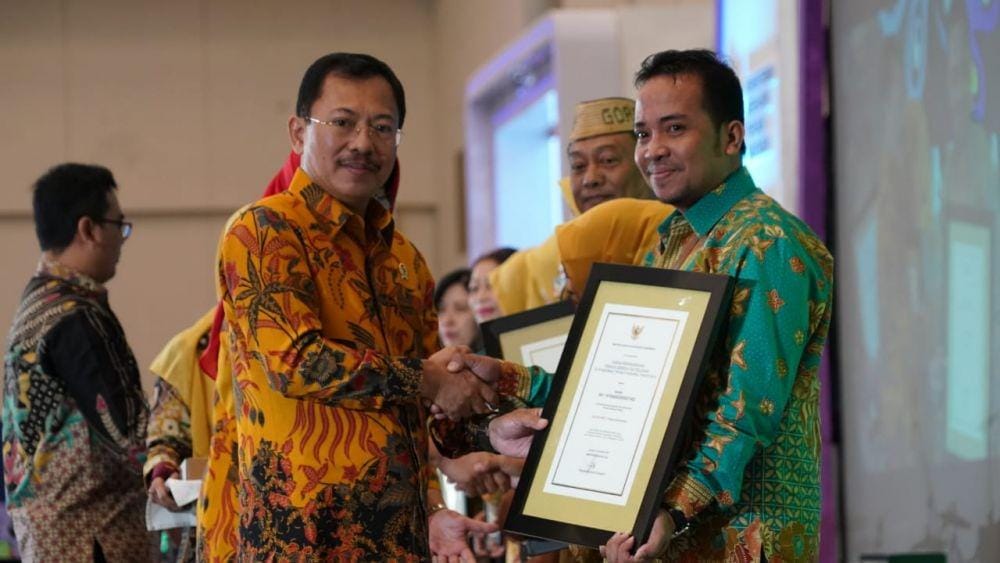 Kepala Puskesmas Borong Rappoa Arwis (kanan) menerima penghargaan dari Menkes Terawan, Sabtu (9/11). Dok. Direktorat Jenderal Pelayanan Kesehatan Kemkes RI