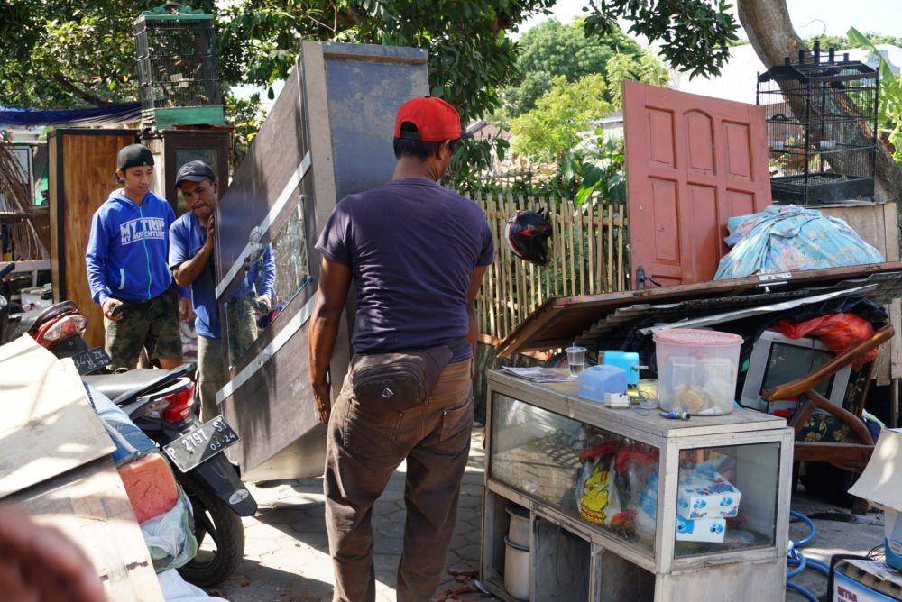 Warga memindahkan perabotan rumah tangga pasca penggusuran rumah. IDN Times/Mohamad Ulil Albab