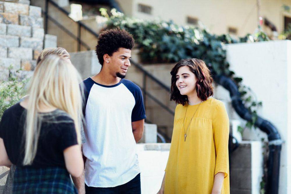 Women and man talking outside