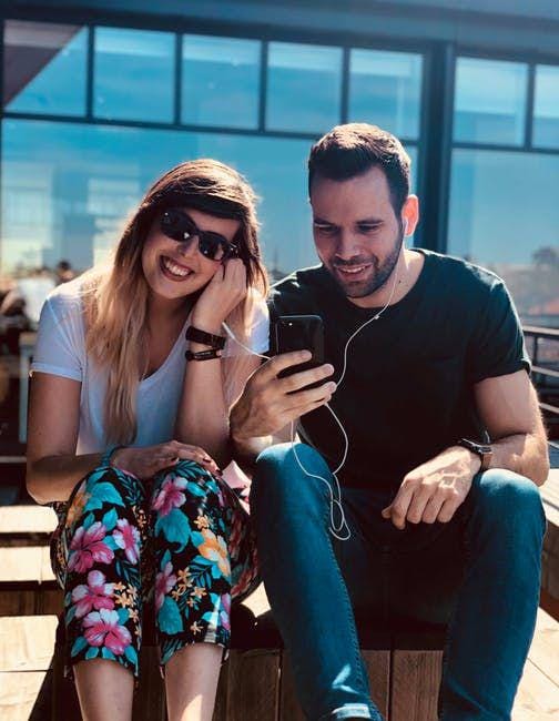 Man and woman using an earphone