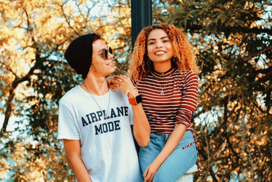 Couple standing beside trees