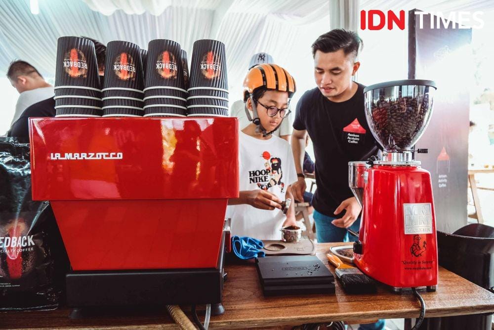 Potret seorang pengunjung yang sedang mencoba membuat kopi sendiri dengan didampingi barista Redback di Sunday Market, Graha Golf Famili Surabaya (1 Desember 2019). IDN Times/Reza Iqbal
