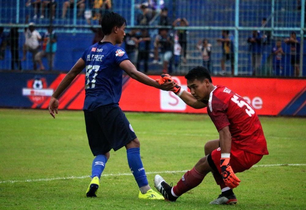 Johan Ahmat Farizie membantu kiper Kalteng Putra, Reky Rahayu. Kedua tim berbagi angka 1-1 di Stadion Kanjuruhan, Minggu (1/12/2019). IDN Times/ Alfi Ramadana