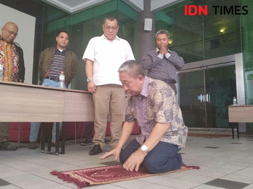 Mantan anggota dewan BPJS TK Syafri Adnan Baharuddin, melakukan sujud syukur di depan awak media dalam konferensi pers di Hotel IBIS, Minggu (8/12) IDN Times/Dini Suciatiningrum.