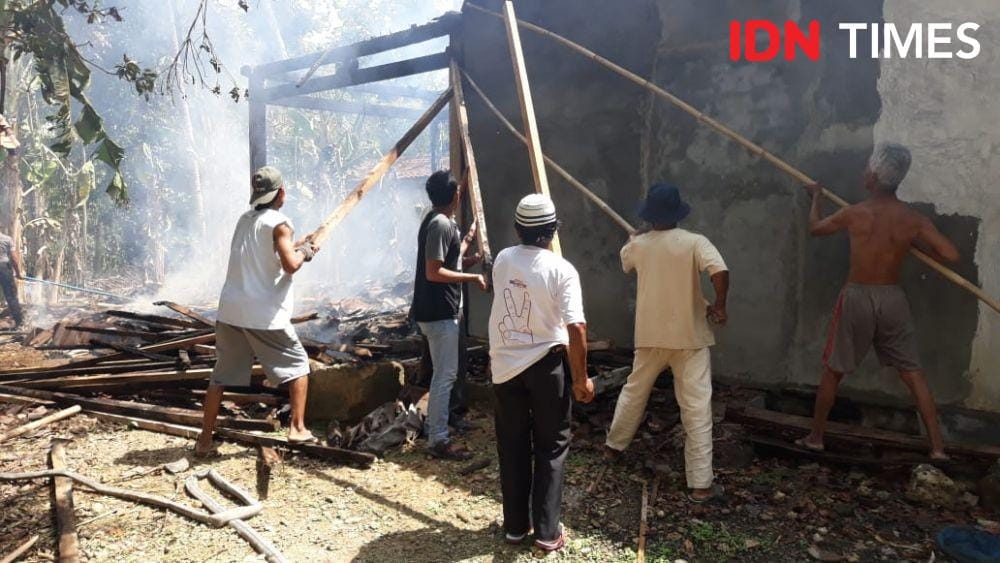 Warga berusaha memadamkan api yang terus membesar. IDN Times/Daruwaskita