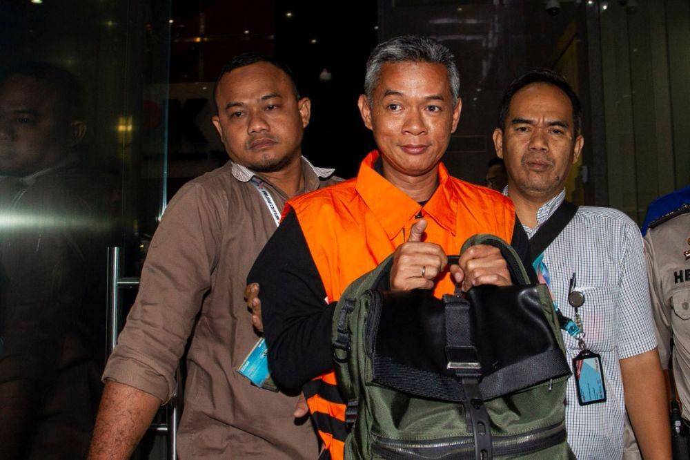 Komisioner KPU Wahyu Setiawan (tengah) mengenakan rompi tahanan usai menjalani pemeriksaan di gedung KPK, Jakarta. (ANTARA FOTO/Dhemas Reviyanto)