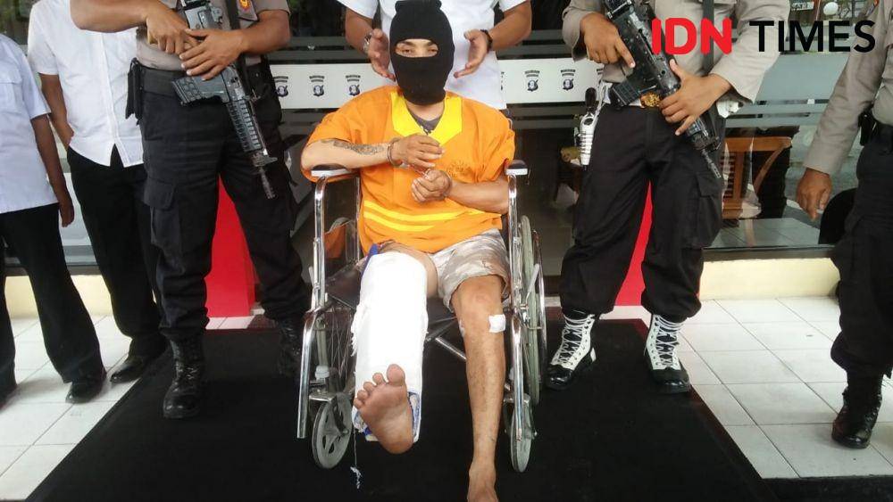 Tersangka pembunuhan, Jahiruddin alias Jahi (37), duduk di kursi roda setelah kedua betisnya ditembak akibat melawan polisi. (IDN Times/Surya Aditya)